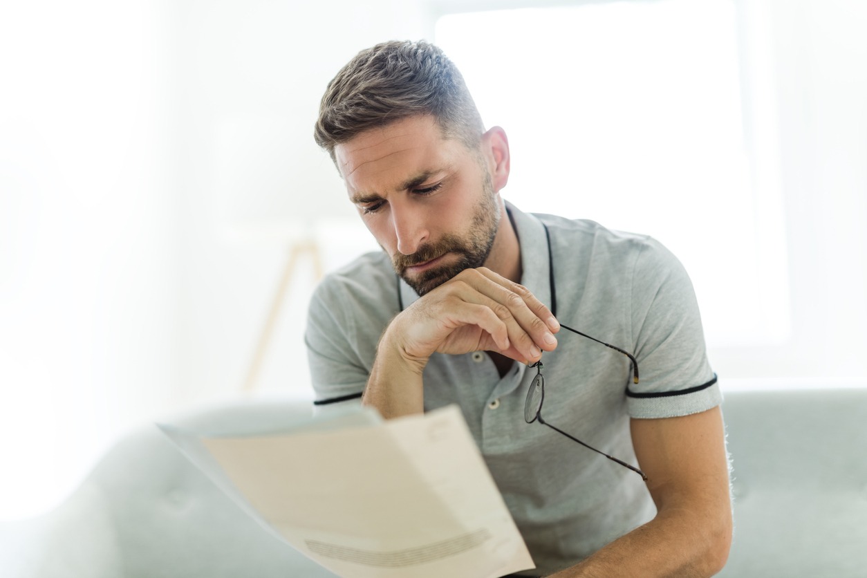 A veteran sitting at home reading a VA decision letter