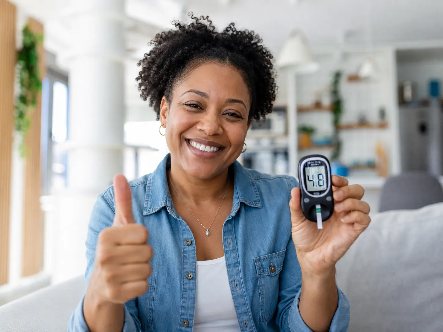 Veteran smiling and holding a blood glucose meter