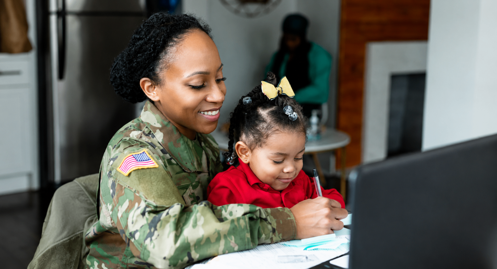 Military mother helping her child with homework at home